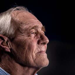 Side shot of an elderly man with a hearing aid