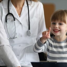 Doctor playing with a child inside her office.
