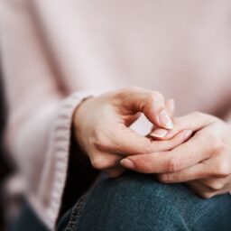 Woman sitting on a sofa and feeling anxious.