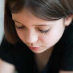 Young girl looking downcast.