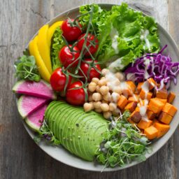 Colorful assortment of healthy foods on a white plate.