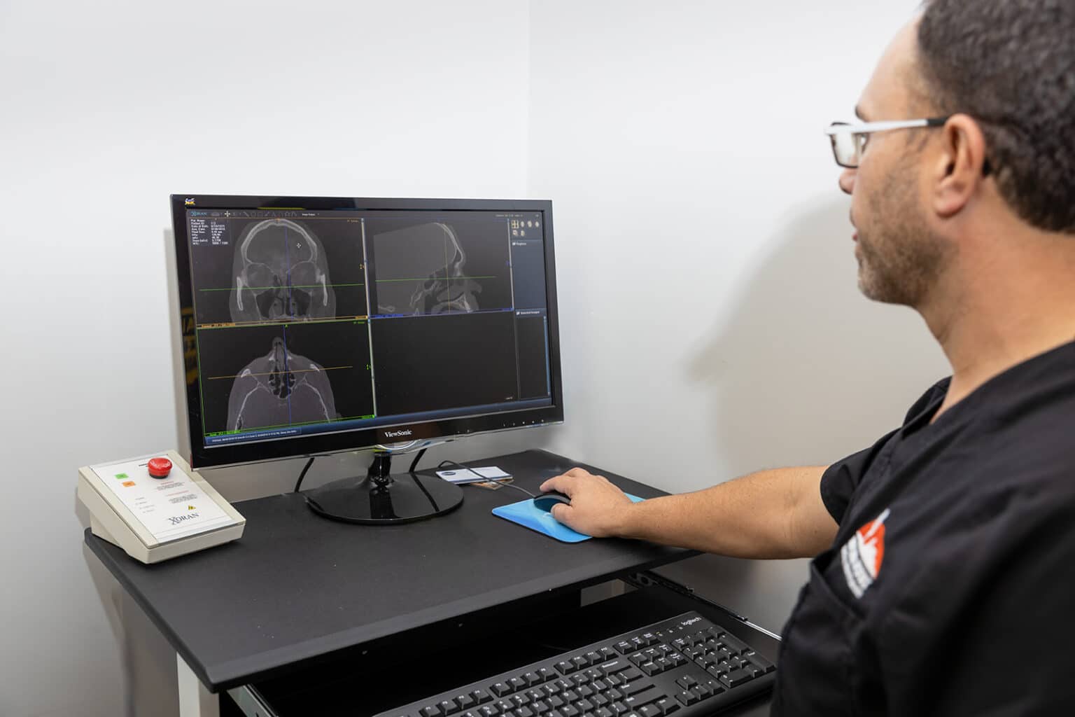 doctor evaluating a mass found in patients head.