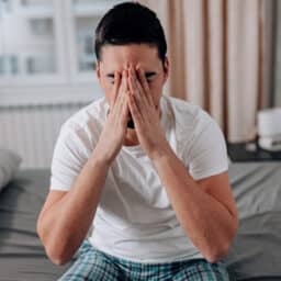 Man with sinus inflammation holding his head